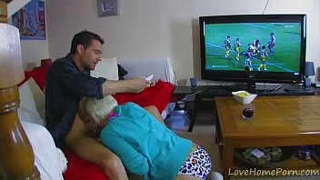 Fucking the blonde girlfriend in the ass while watching football match