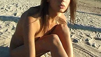 Beautiful fresh faced teen plays at the beach nude