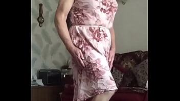 Transvestite Pose in lounge wearing long dress
