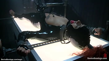 Shackled ebony slut Daisy Ducati on illuminating table dressed in latex gets whipped then in other device bondage positions takes corporal punishment